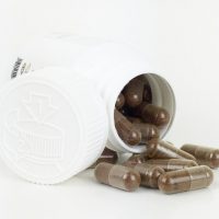 Dark-Brown-capsules-spilled-from-container